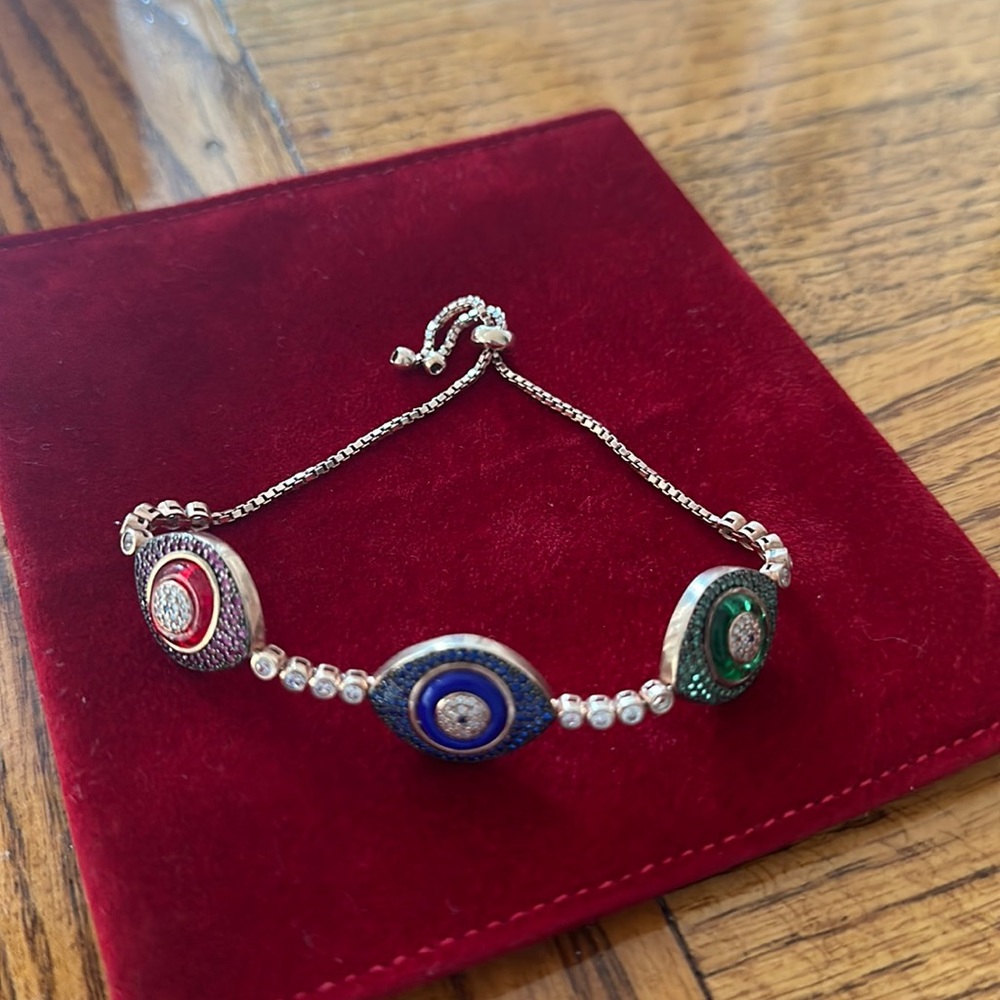 Triple evil eye bracelet with multiple color crystals and adjustable closure